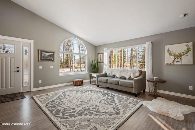 living room with baseboards, visible vents, high vaulted ceiling, and wood finished floors