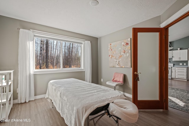 bedroom with baseboards and wood finished floors