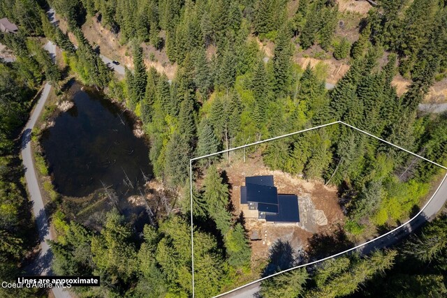 birds eye view of property with a view of trees