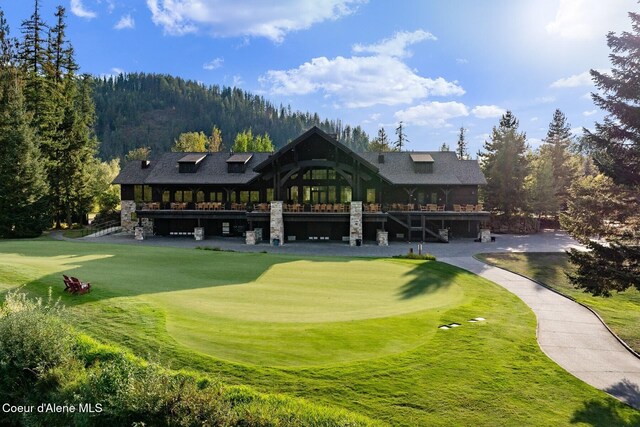 view of property's community with a lawn and golf course view
