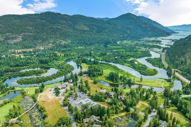birds eye view of property with a water and mountain view