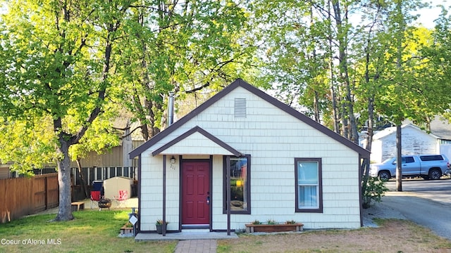 bungalow-style home with fence