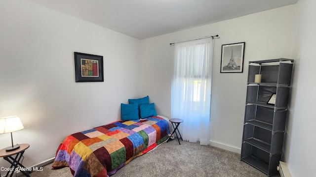 bedroom featuring baseboards and carpet