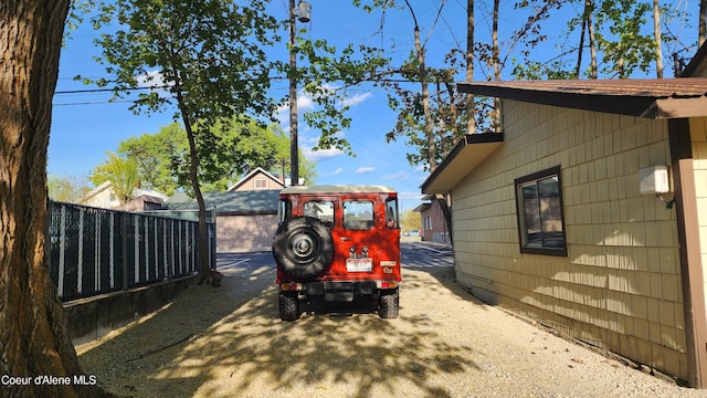 view of home's exterior with fence