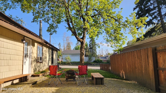 view of yard featuring fence and a fire pit