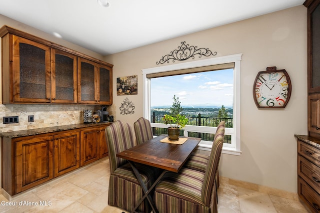 5969 W Highland Dr, Coeur Dalene, ID 83814 - dining area featuring baseboards and stone tile flooring