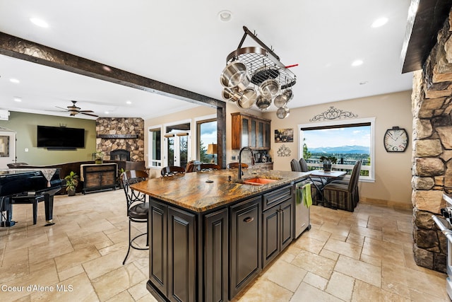 5969 W Highland Dr, Coeur Dalene, ID 83814 - kitchen with a sink, ceiling fan, a stone fireplace, and stone tile flooring