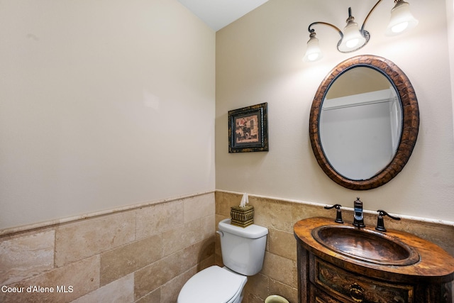 5969 W Highland Dr, Coeur Dalene, ID 83814 - bathroom featuring vanity, a wainscoted wall, toilet, and tile walls