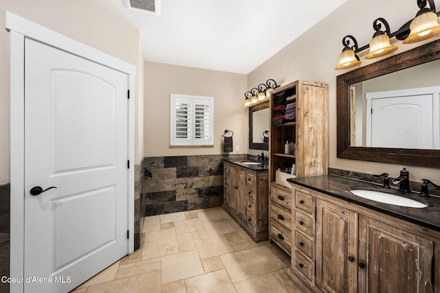 5969 W Highland Dr, Coeur Dalene, ID 83814 - full bathroom with stone tile floors, visible vents, wainscoting, and vanity
