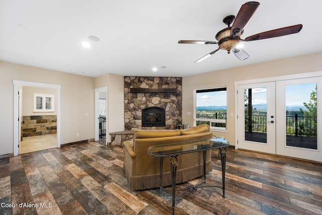 5969 W Highland Dr, Coeur Dalene, ID 83814 - living area featuring ceiling fan, french doors, dark wood finished floors, and a stone fireplace