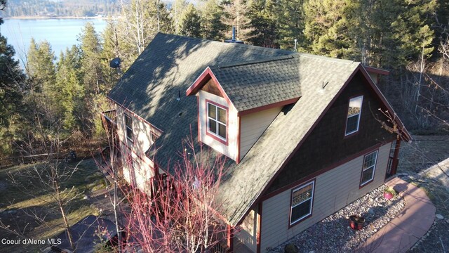 314 Overlake View Rd, Cocolalla, ID 83813 - view of property exterior featuring a shingled roof, a view of trees, and a water view