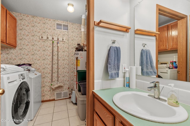 404 W 18th Ave, Post Falls, ID 83854 - bathroom with wallpapered walls, baseboards, visible vents, tile patterned flooring, and washer and clothes dryer