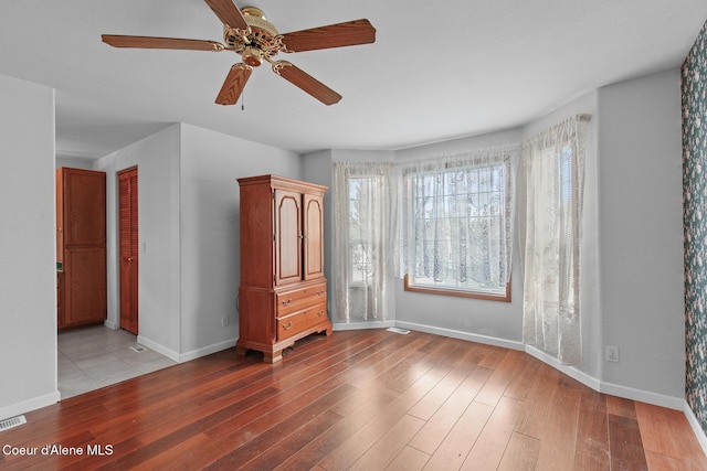 404 W 18th Ave, Post Falls, ID 83854 - unfurnished room featuring a ceiling fan, baseboards, and wood finished floors
