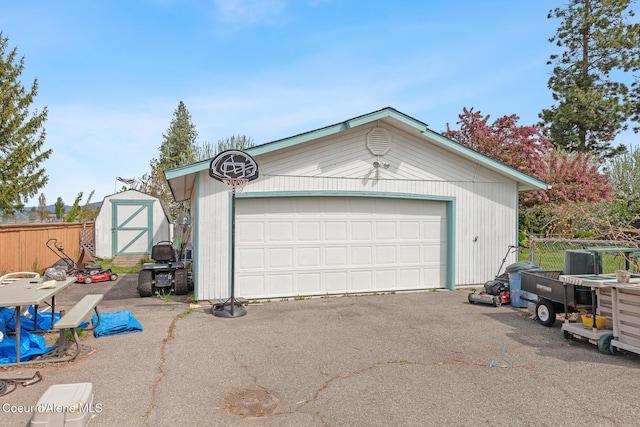 404 W 18th Ave, Post Falls, ID 83854 - detached garage featuring a storage unit and fence