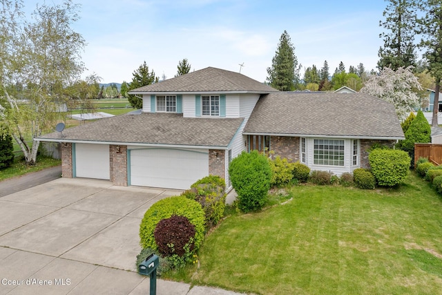 404 W 18th Ave, Post Falls, ID 83854 - view of front facade featuring brick siding, an attached garage, a shingled roof, concrete driveway, and a front lawn