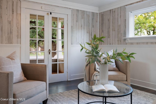 723 Forest Ave, Sandpoint, ID 83864 - living area with dark wood-style floors, ornamental molding, wood walls, and a wainscoted wall