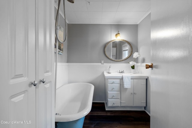 723 Forest Ave, Sandpoint, ID 83864 - full bathroom with a freestanding bath, vanity, wood finished floors, and a wainscoted wall
