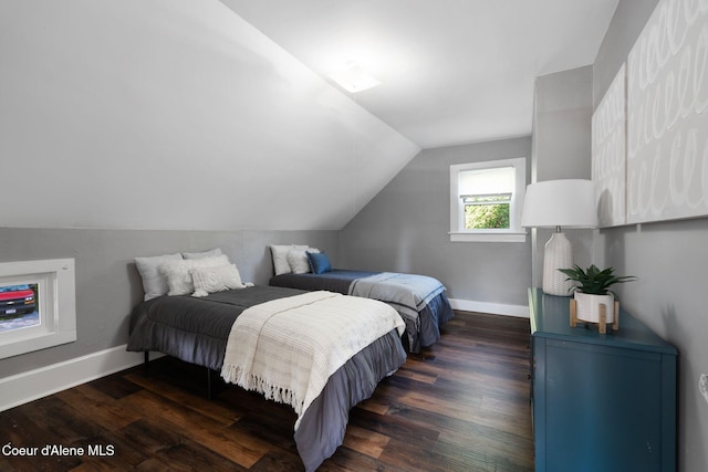 723 Forest Ave, Sandpoint, ID 83864 - bedroom with dark wood-style floors, lofted ceiling, and baseboards