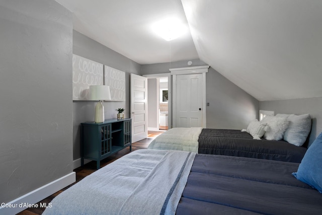 723 Forest Ave, Sandpoint, ID 83864 - bedroom with lofted ceiling, wood finished floors, and baseboards