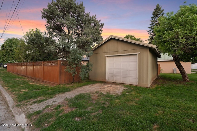 723 Forest Ave, Sandpoint, ID 83864 - garage at dusk featuring dirt driveway and a garage