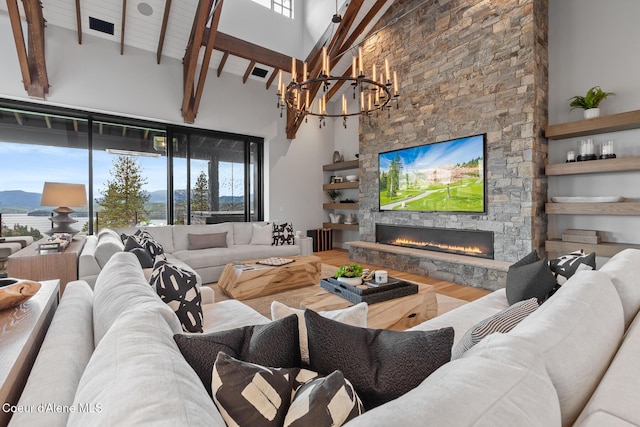 6869 S Gozzer Rd Unit C201, Harrison, ID 83833 - living area featuring a fireplace, high vaulted ceiling, a chandelier, beam ceiling, and wood finished floors