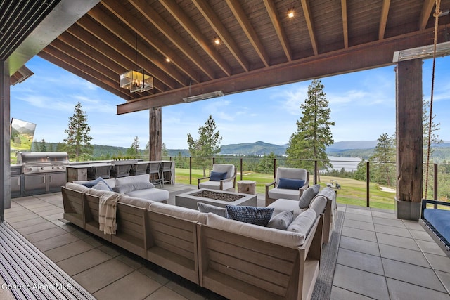6869 S Gozzer Rd Unit C201, Harrison, ID 83833 - view of patio with an outdoor living space with a fire pit and a mountain view