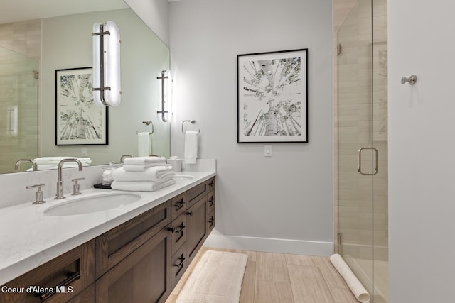 6869 S Gozzer Rd Unit C201, Harrison, ID 83833 - bathroom featuring double vanity, a shower stall, and baseboards
