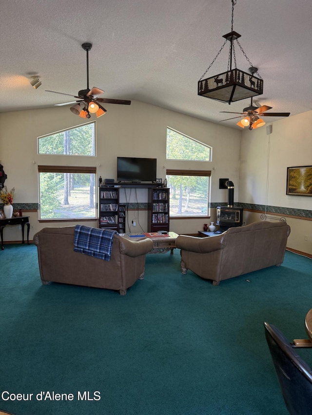 1959 Thimbleberry Ln, Sandpoint, ID 83864 - living area featuring a textured ceiling, plenty of natural light, a ceiling fan, and carpet floors