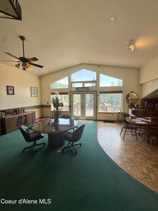 1959 Thimbleberry Ln, Sandpoint, ID 83864 - dining space featuring vaulted ceiling, a textured ceiling, a wealth of natural light, and a ceiling fan