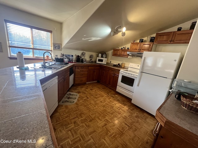 1959 Thimbleberry Ln, Sandpoint, ID 83864 - kitchen with lofted ceiling, exhaust hood, brown cabinetry, white appliances, and a sink