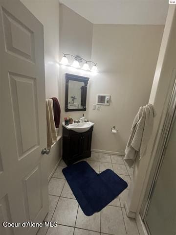 1959 Thimbleberry Ln, Sandpoint, ID 83864 - bathroom with a shower stall, tile patterned flooring, and vanity