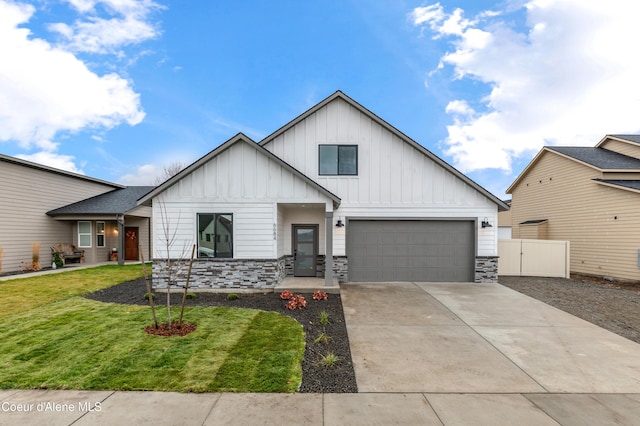 6696 Portrush Dr, Rathdrum, ID 83858 - modern farmhouse with board and batten siding, stone siding, driveway, and a front yard