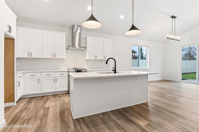 6696 Portrush Dr, Rathdrum, ID 83858 - kitchen with light wood-type flooring, a sink, wall chimney exhaust hood, and tasteful backsplash