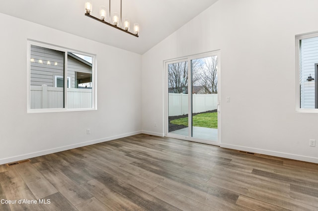 6696 Portrush Dr, Rathdrum, ID 83858 - unfurnished room with an inviting chandelier, wood finished floors, and visible vents