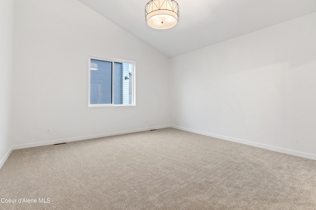 6696 Portrush Dr, Rathdrum, ID 83858 - carpeted spare room featuring baseboards and lofted ceiling