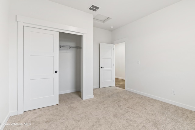 6696 Portrush Dr, Rathdrum, ID 83858 - unfurnished bedroom with carpet flooring, attic access, baseboards, visible vents, and a closet