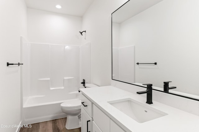 6696 Portrush Dr, Rathdrum, ID 83858 - full bathroom featuring vanity, toilet, recessed lighting, wood finished floors, and shower / bathing tub combination