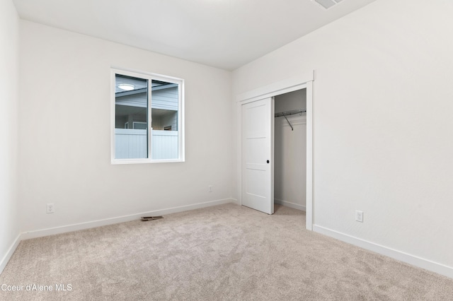 6696 Portrush Dr, Rathdrum, ID 83858 - unfurnished bedroom with baseboards, carpet, visible vents, and a closet