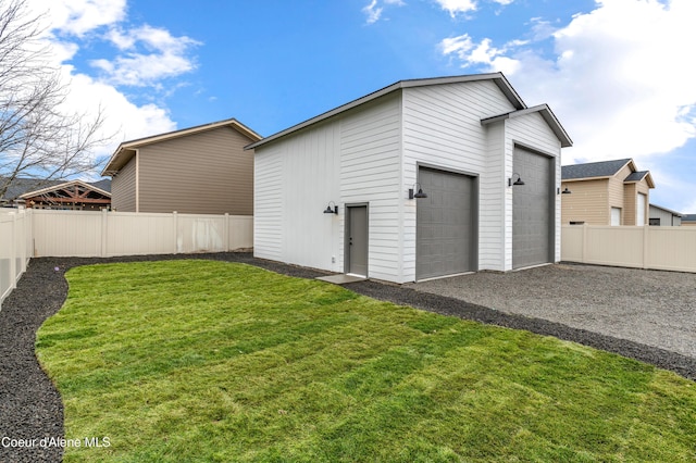 6696 Portrush Dr, Rathdrum, ID 83858 - back of property with a lawn, a fenced backyard, and an outdoor structure