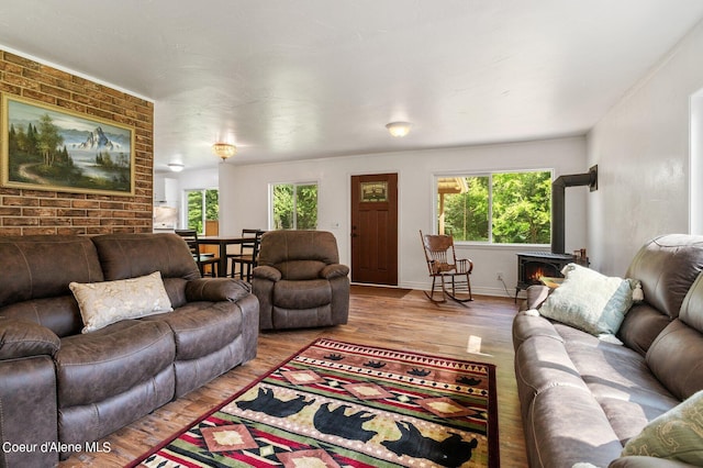 living room featuring baseboards, plenty of natural light, and wood finished floors