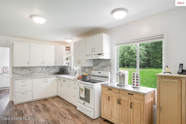 kitchen with open shelves, white range with electric cooktop, light countertops, under cabinet range hood, and backsplash