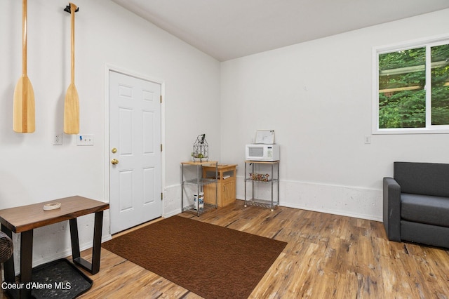 entrance foyer featuring baseboards and wood finished floors