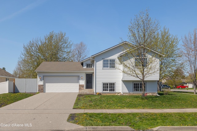 7435 N Cornwall St, Coeur Dalene, ID 83815 - split level home featuring fence, an attached garage, a front lawn, and driveway