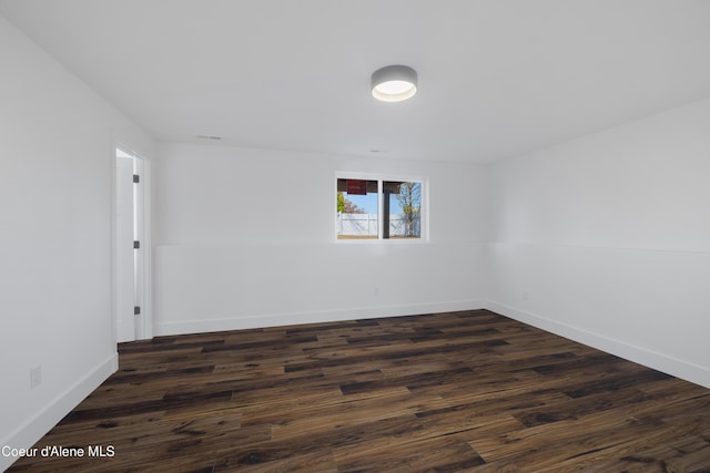 7435 N Cornwall St, Coeur Dalene, ID 83815 - spare room with baseboards and dark wood-style floors