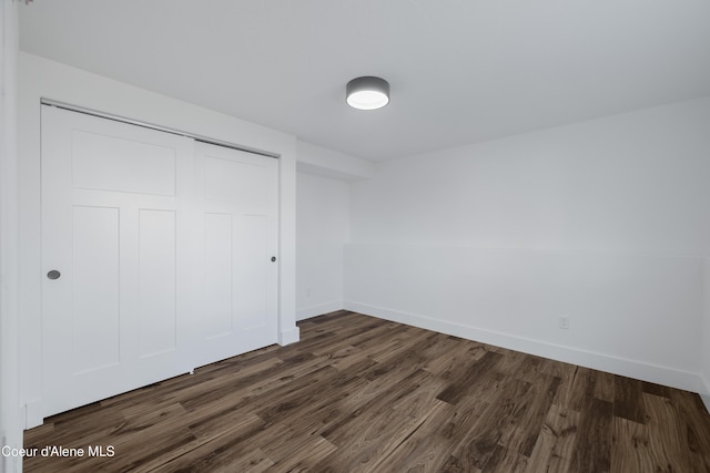 7435 N Cornwall St, Coeur Dalene, ID 83815 - unfurnished bedroom with baseboards, dark wood finished floors, and a closet