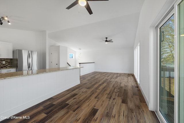 7435 N Cornwall St, Coeur Dalene, ID 83815 - unfurnished living room with dark wood-type flooring, baseboards, and ceiling fan