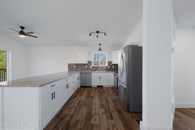7435 N Cornwall St, Coeur Dalene, ID 83815 - kitchen with ceiling fan, white cabinetry, a peninsula, stainless steel appliances, and tasteful backsplash