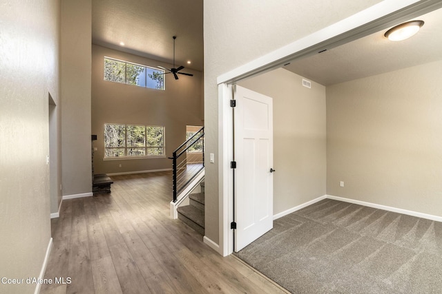 7587 E Duke Ln, Athol, ID 83801 - interior space with baseboards, a ceiling fan, wood finished floors, and a towering ceiling