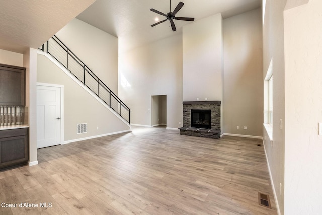 7587 E Duke Ln, Athol, ID 83801 - unfurnished living room featuring a ceiling fan, a high ceiling, visible vents, and light wood-style flooring