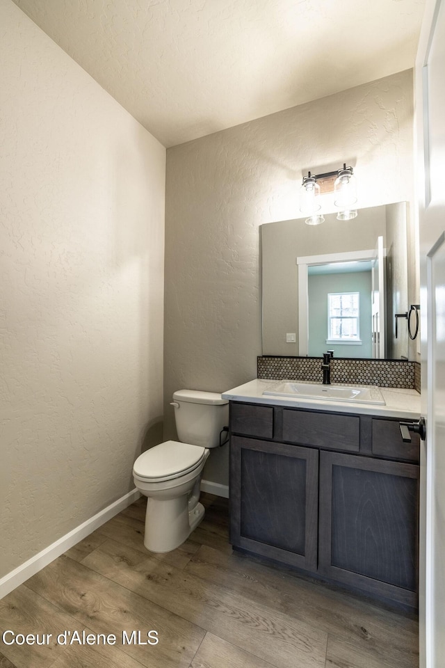 7587 E Duke Ln, Athol, ID 83801 - bathroom with vanity, a textured wall, wood finished floors, toilet, and baseboards